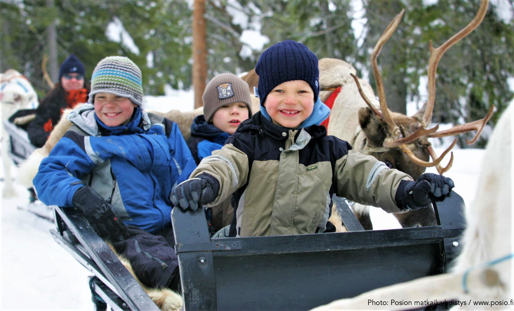 Kids excited to take a reindeer sleigh ride in Posio
